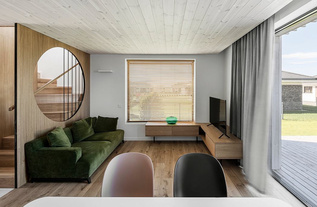 Spacious living room with wooden ceiling, large window, and minimalist furniture.