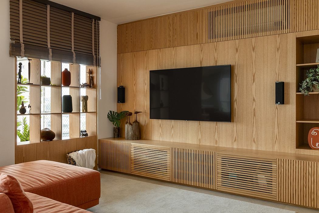 Warm, wooden interior with built-in TV unit, shelves, and textured wall paneling.