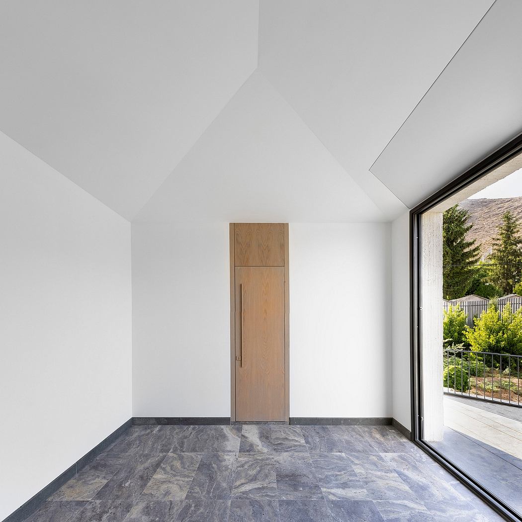 Sleek modern room with wooden built-in cabinet, large window, and slate tile flooring.