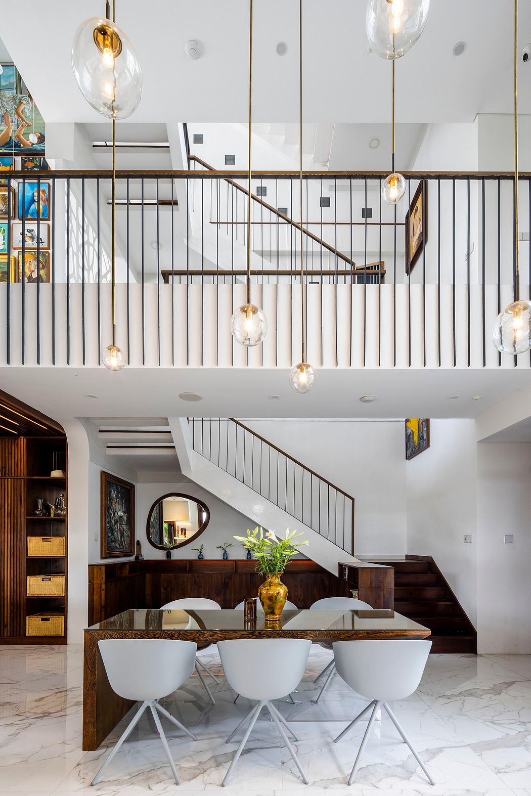 Sleek, modern interior with wood accents, hanging pendant lights, and an open staircase.