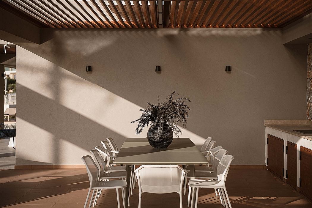 Warm, modern dining space with wooden ceiling, neutral walls, and stylish furnishings.