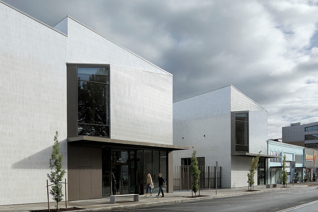 Contemporary architecture with sleek, angular building facades, large windows, and minimal landscaping.