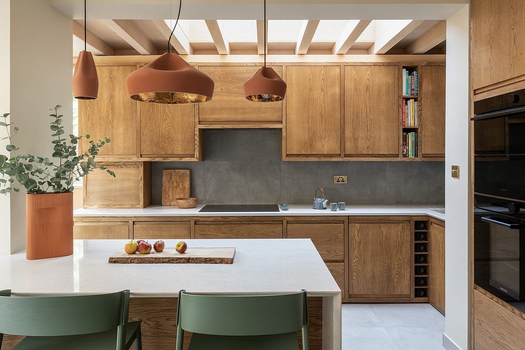Modern kitchen with warm oak cabinets, concrete backsplash, and hanging copper lamps.
