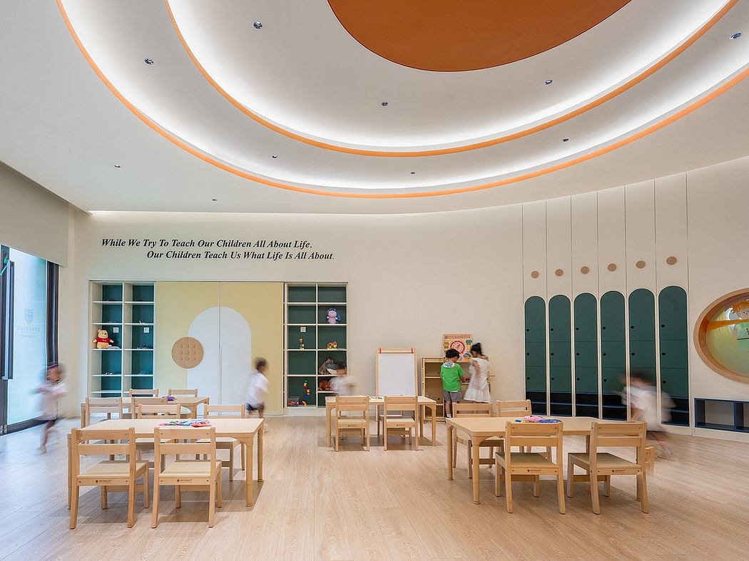 Vibrant, geometric ceiling design frames a cozy, child-friendly classroom.