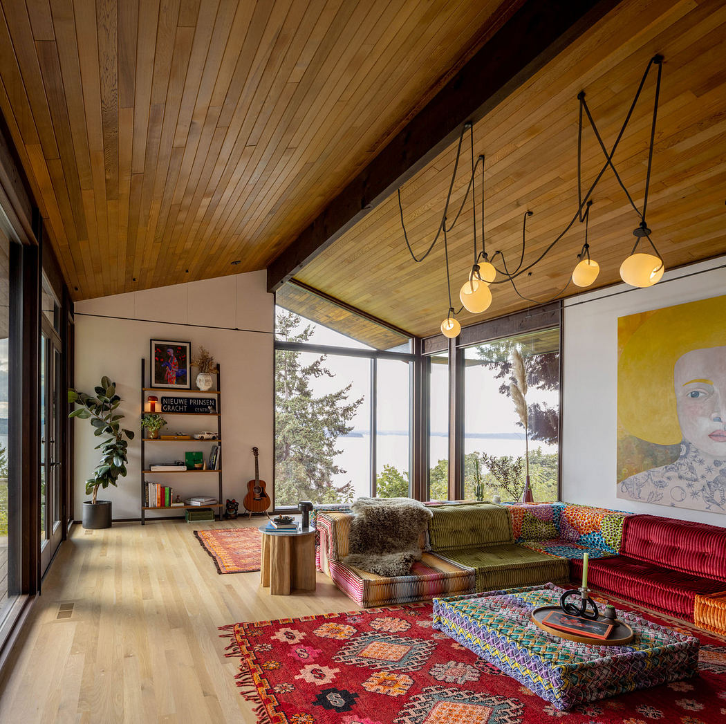 Vibrant living room with wooden vaulted ceiling, eclectic furnishings, and panoramic windows.