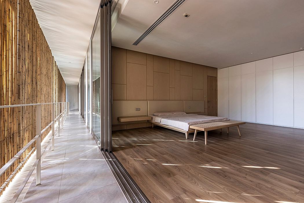 A modern, spacious bedroom with wood paneling, glass walls, and a minimalist bed frame.