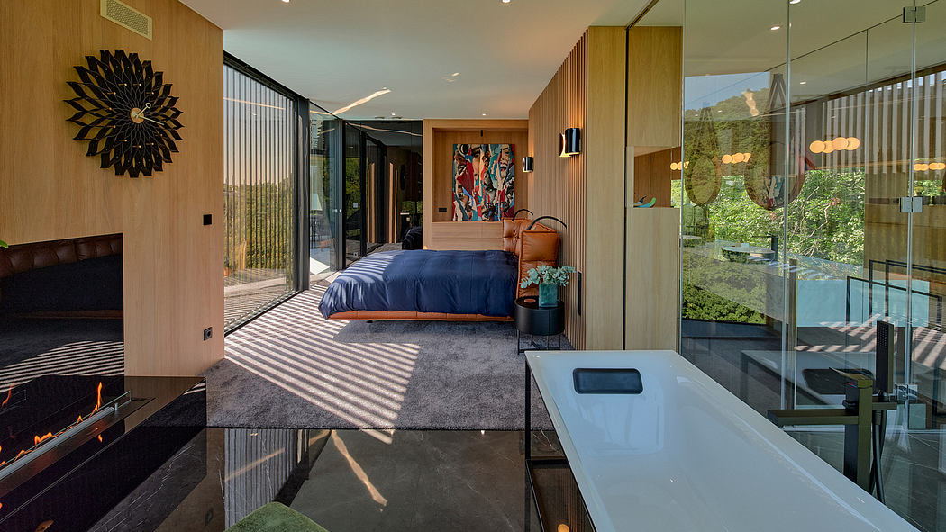Luxurious modern bedroom with floor-to-ceiling windows, stylish furniture, and artwork.