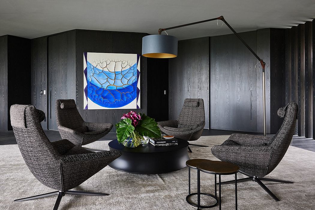 Dramatic modern living room with textured gray walls, sculptural chairs, and statement art.