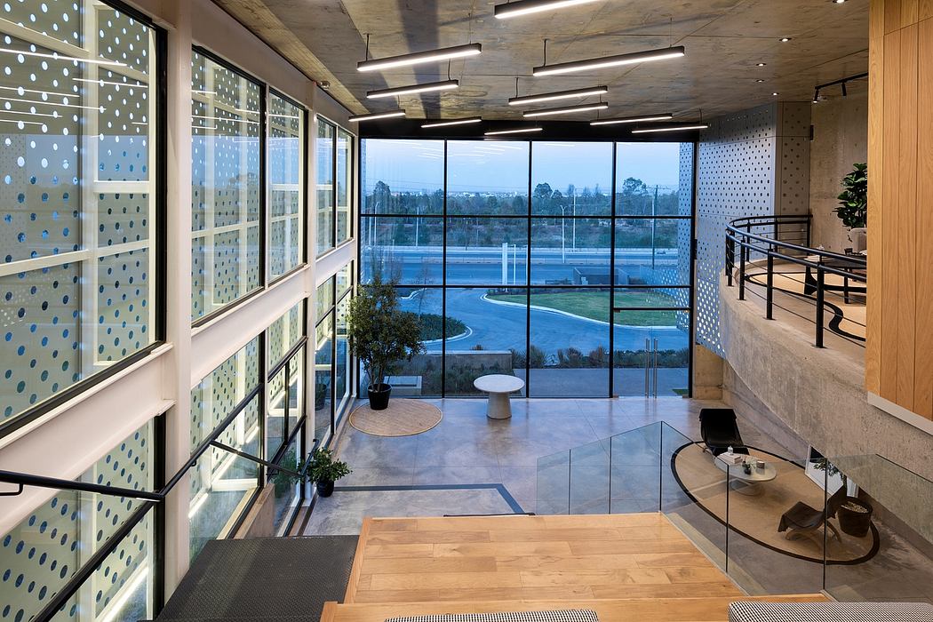 Expansive glass walls, sleek concrete, and contemporary lighting create a striking interior.