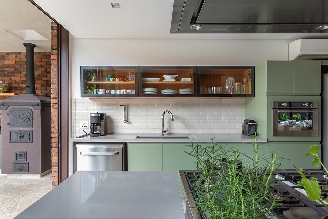 Stylish modern kitchen with open shelves, subway tiles, and green cabinetry.