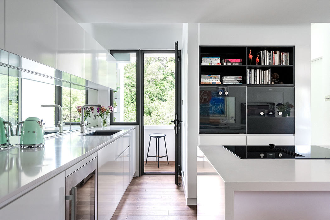 Sleek, modern kitchen with floor-to-ceiling windows, built-in shelving, and seamless countertops.