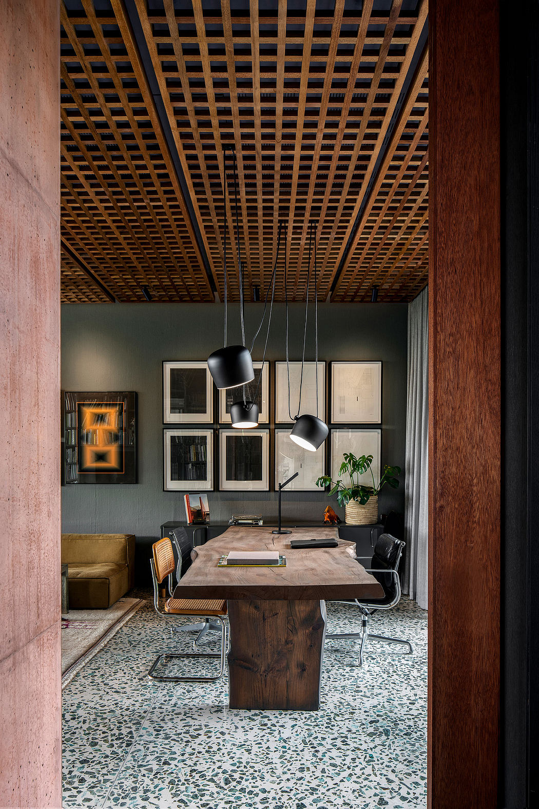 Wooden grid ceiling, tiled floor, wooden table, and minimalist black lighting fixtures.
