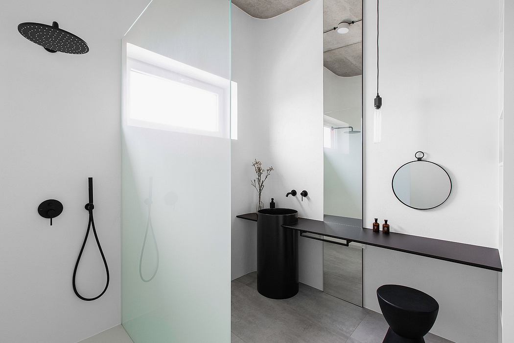 Modern bathroom interior with minimalist black and white design elements.