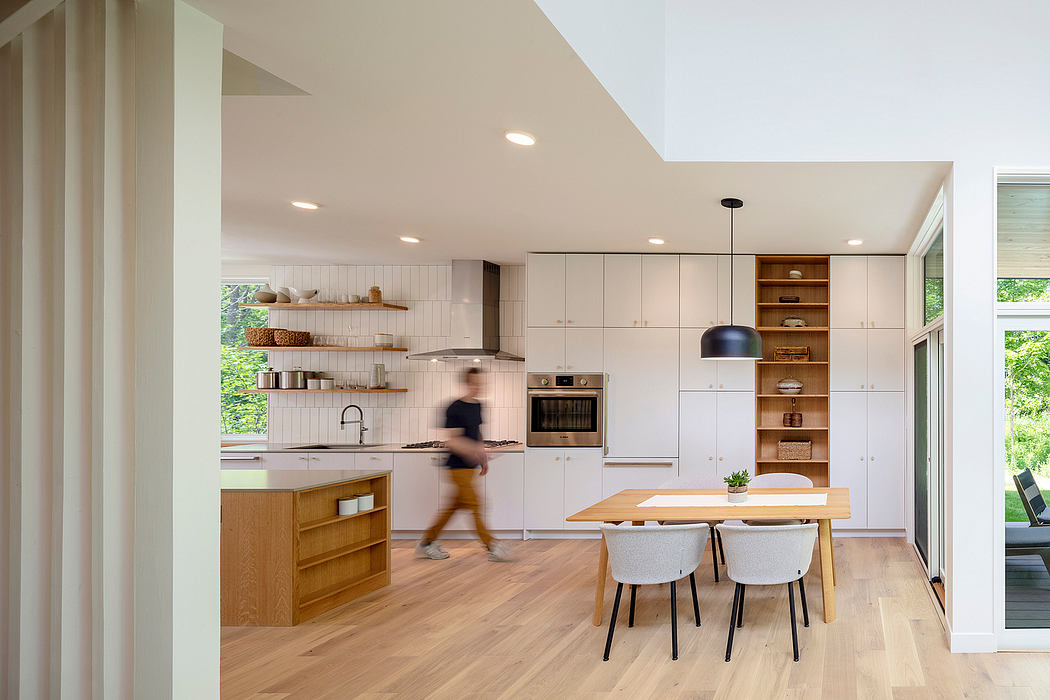 Bright, modern kitchen with open shelving, wooden accents, and a dining area.