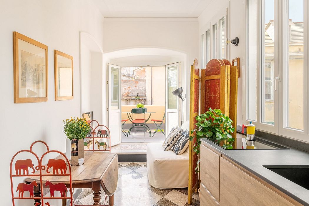 Bright, spacious room with white walls, arched doorway, and mix of modern and antique furnishings.