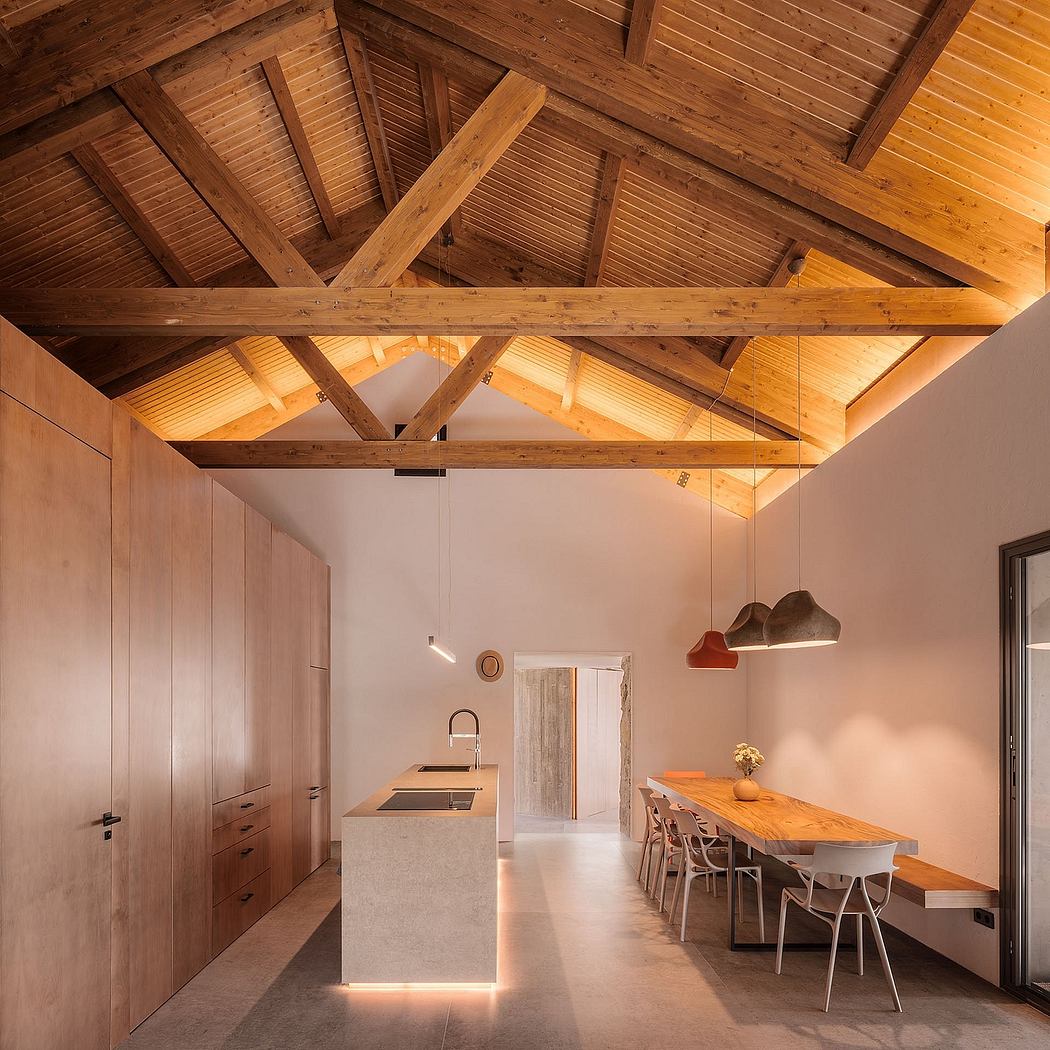 A cozy, rustic kitchen and dining space with exposed wooden beams and contemporary furnishings.