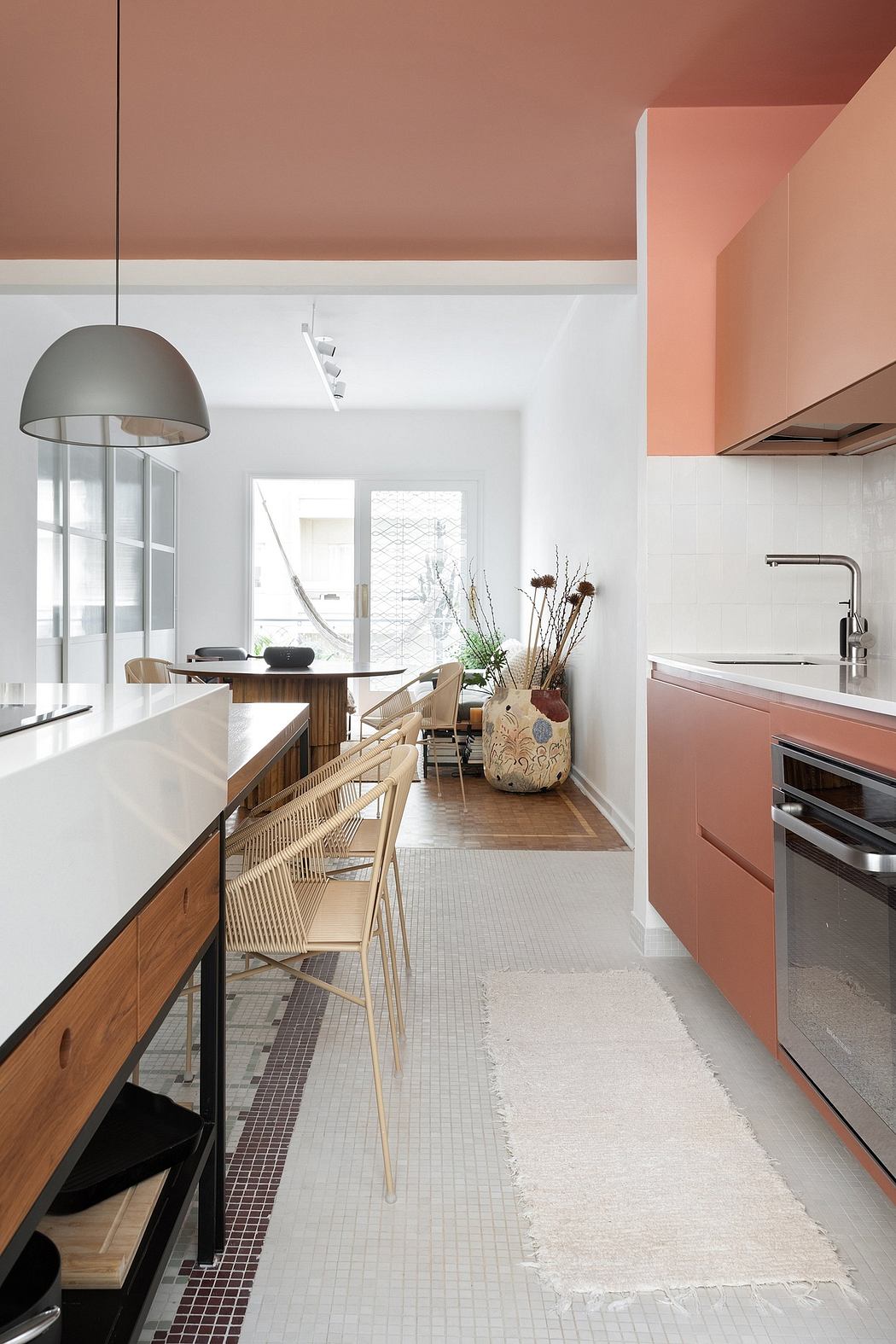 A modern, minimalist kitchen with a warm color palette, natural wood, and sleek fixtures.