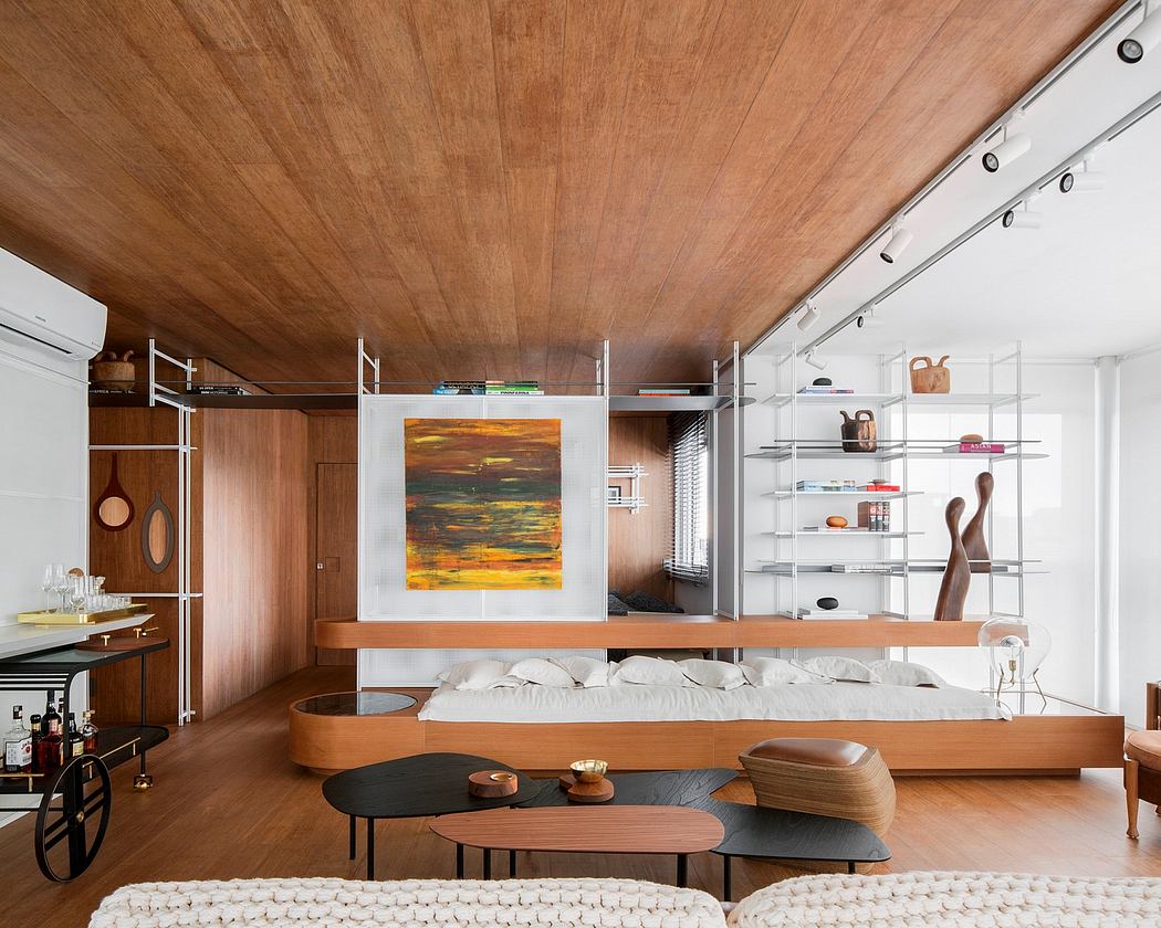 Warm, minimalist space with wooden ceiling, shelves, and low-profile furnishings creating a cozy ambiance.