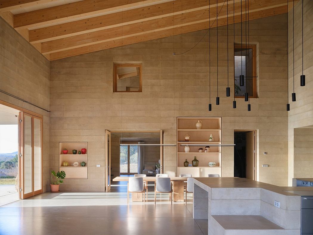 A modern, minimalist kitchen and dining space with wooden beams, shelving, and lighting fixtures.
