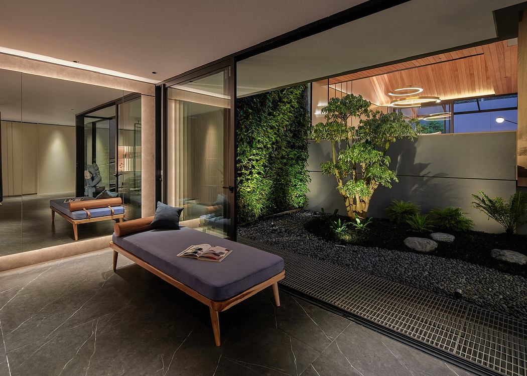 Sleek modern interior with floor-to-ceiling glass walls, lush greenery, and minimalist decor.