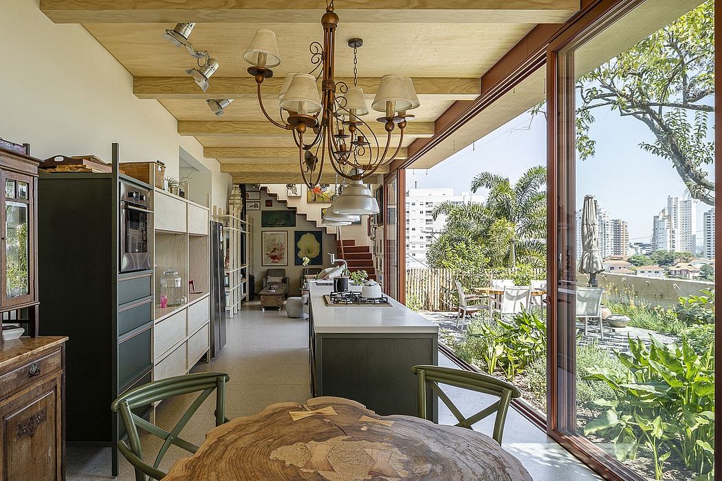 A cozy kitchen with rustic wooden beams, modern appliances, and a lush garden view beyond.
