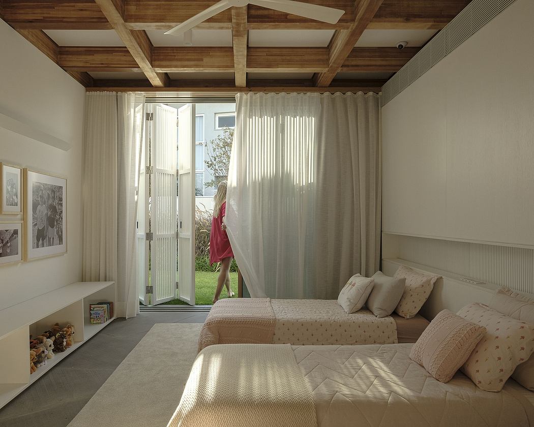 Cozy bedroom with wooden ceiling beams, sliding glass doors, and plush bedding.