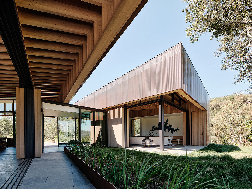 Modern wooden structure with large glass walls showcasing natural landscape.