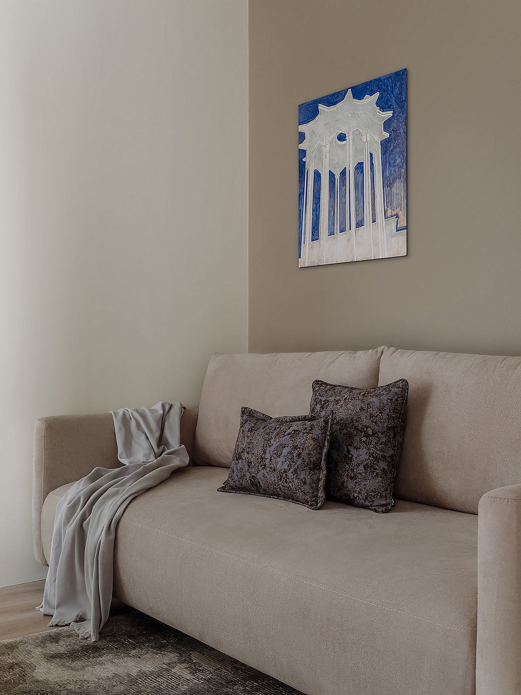 Minimal living room decor with modern artwork and plush sofa invites relaxation.