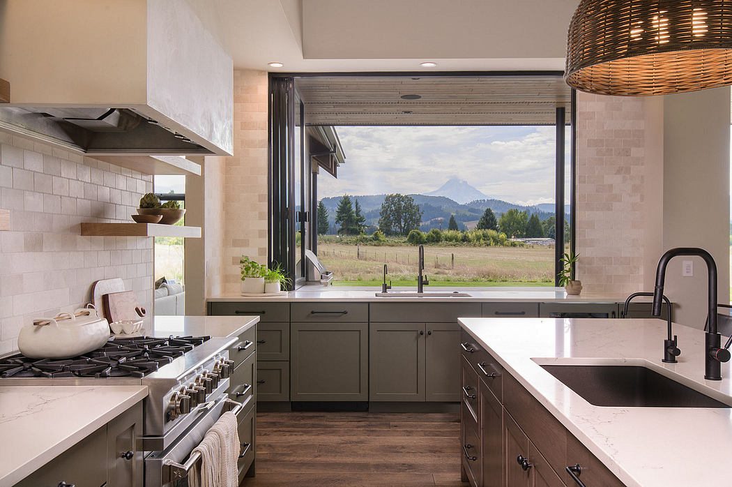 A modern, open-concept kitchen with expansive views of the surrounding mountains and countryside.
