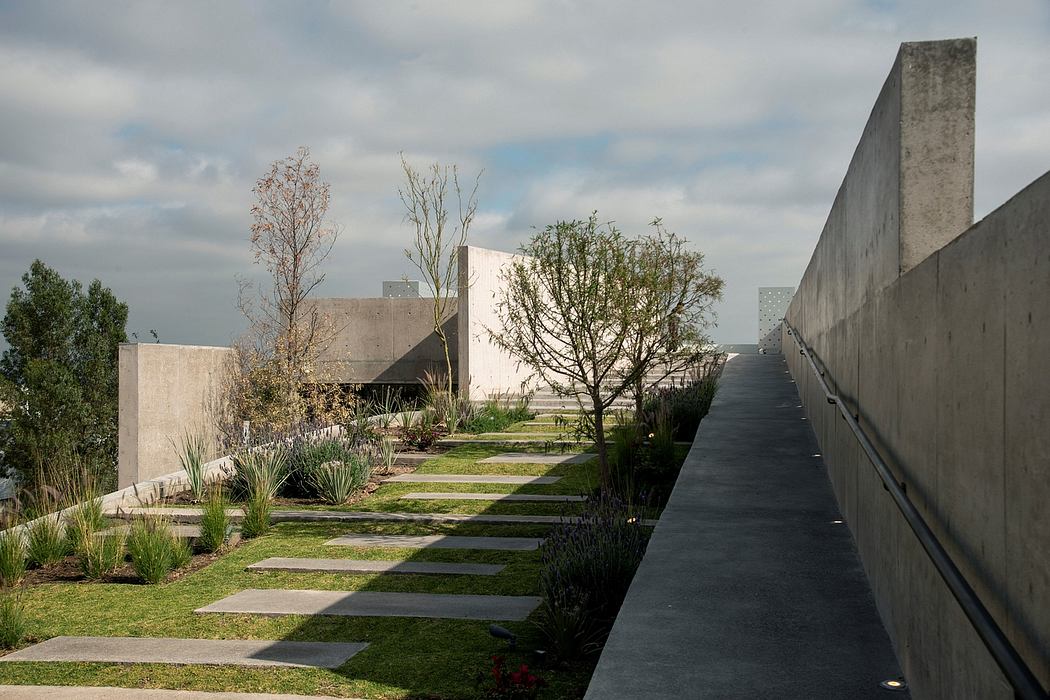 A modern architectural landscape with concrete structures, walkways, and landscaping.