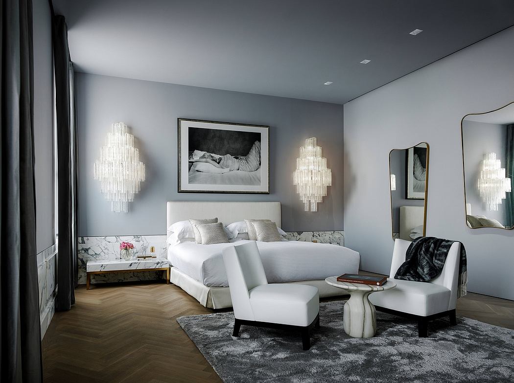 Elegant bedroom with sleek gray walls, dramatic lighting fixtures, and plush furnishings.