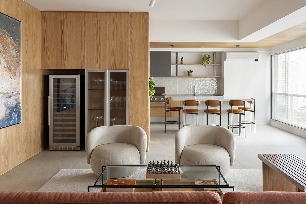 Spacious open-plan kitchen and living area with modern, wooden cabinetry and furniture.