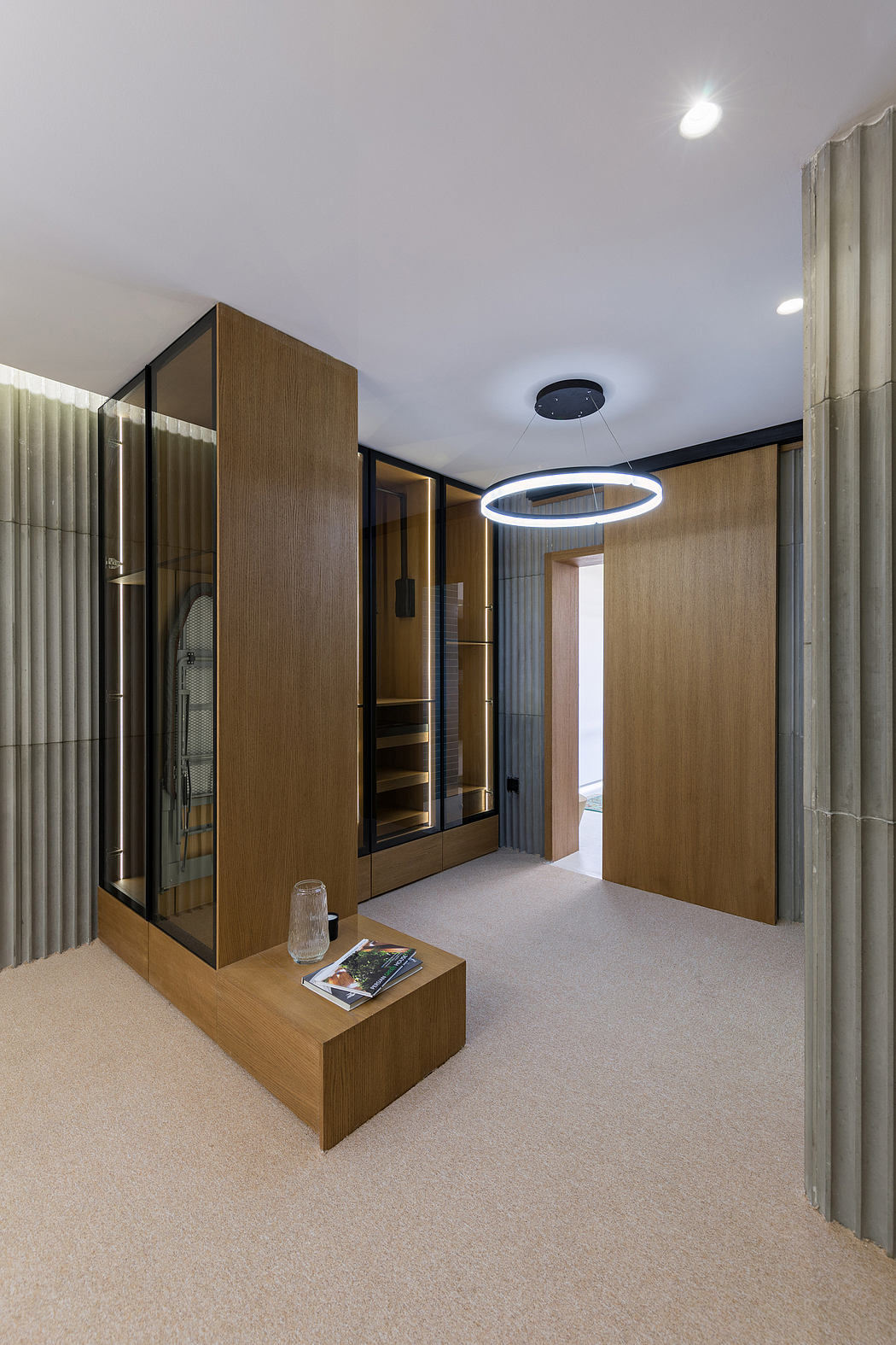 Sleek and modern interior design with wooden panels, glass elements, and a circular light fixture.