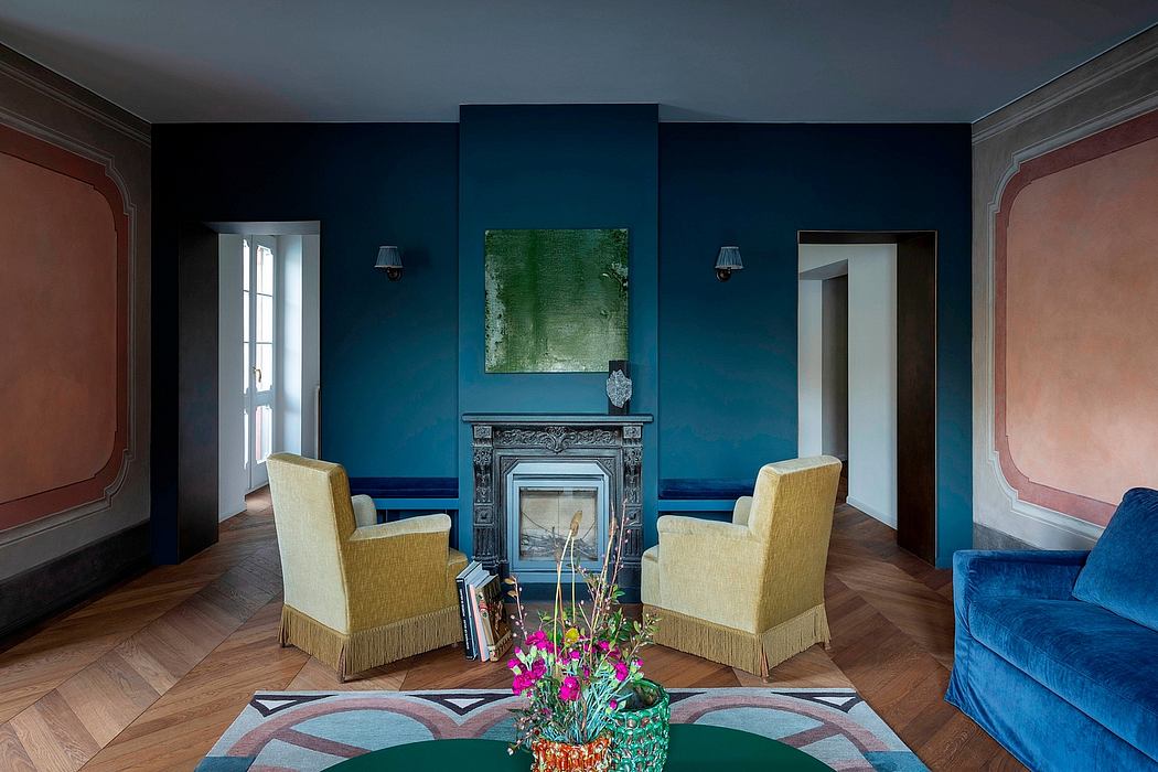 Cozy sitting area with antique fireplace, vibrant blue walls, and eclectic decor.