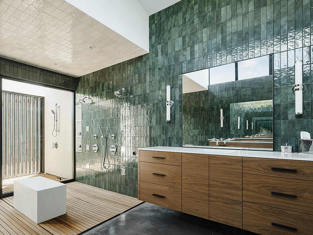 Luxurious bathroom with green tiled walls, wooden vanity, and modern fixtures.