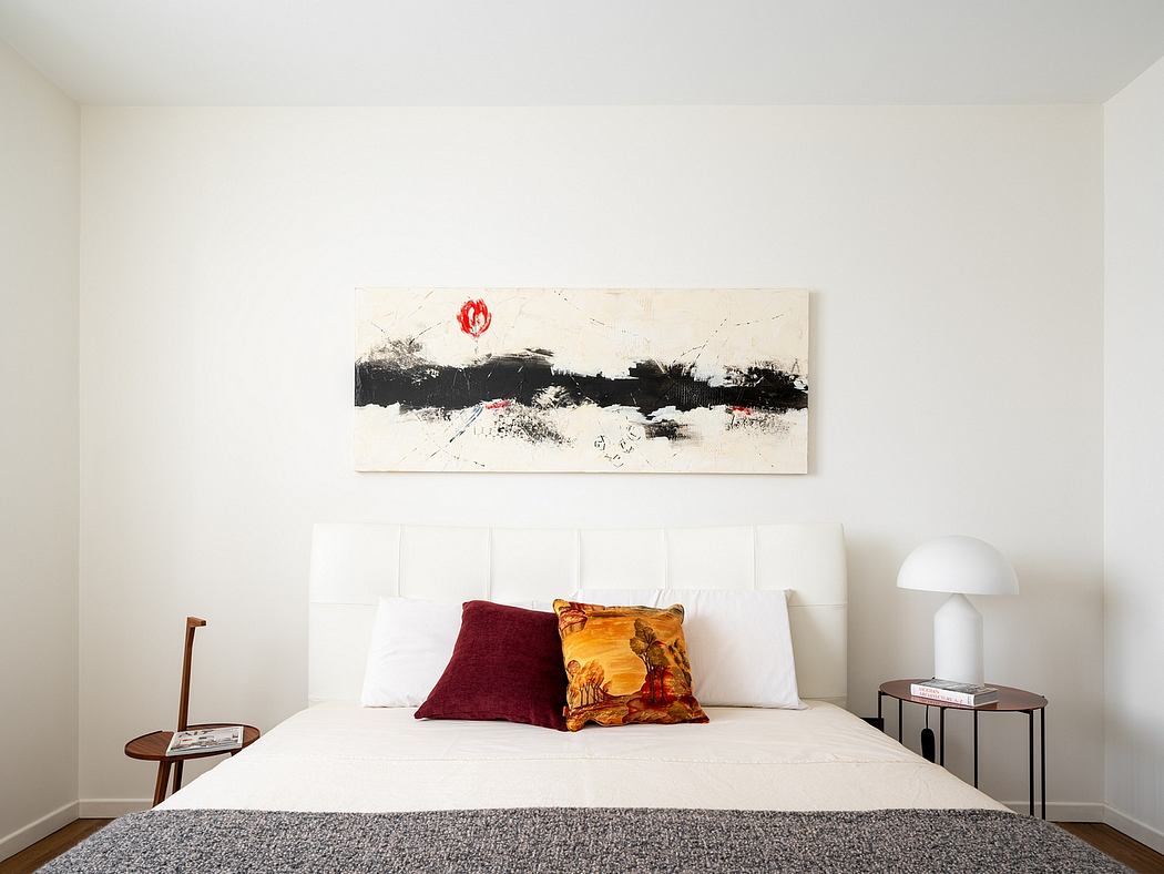 A modern, minimalist bedroom with a large abstract painting above the bed.