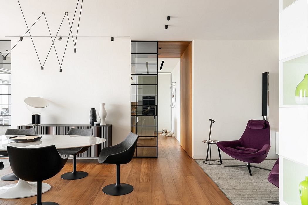 Sleek, modern interior with geometric lighting, wooden flooring, and a striking purple chair.