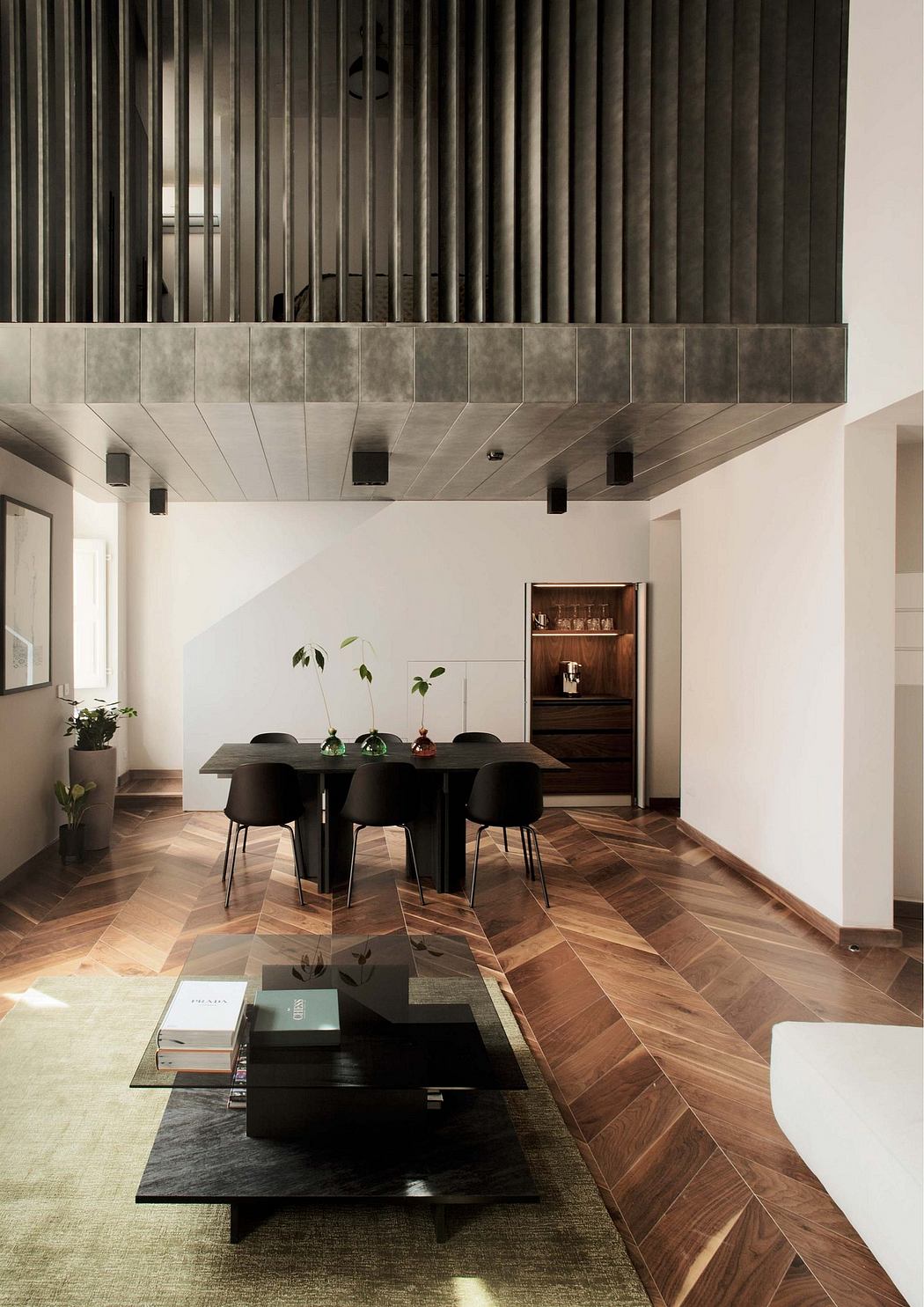 Sleek, modern dining area with textured ceiling, dark wood floors, and minimalist furnishings.