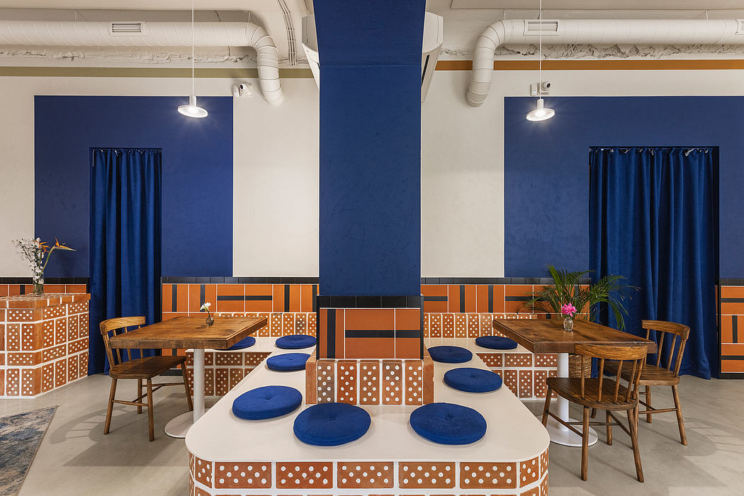 An interior design featuring bold blue walls, patterned brick tiles, and wooden furniture.