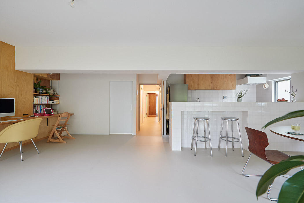 Modern, open-concept living space with minimalist wood and white décor, kitchen island.
