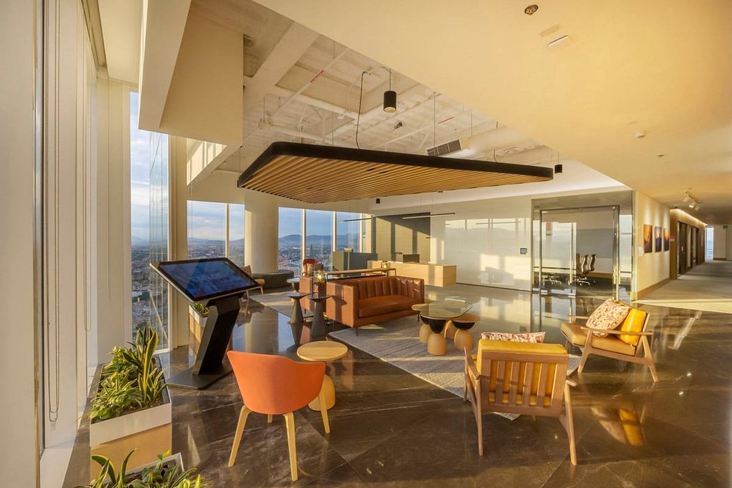 Luxurious open-concept office space with wooden beams, lounge furniture, and panoramic city views.