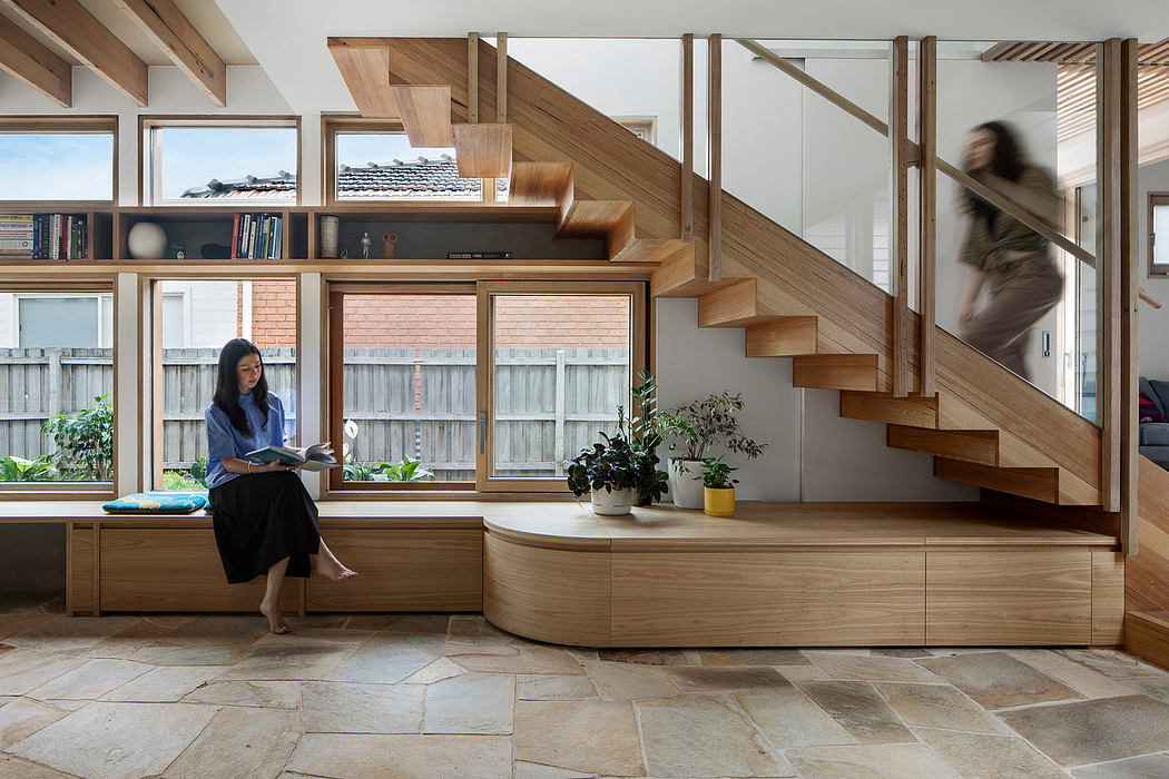 Elegant wooden staircase and built-in cabinetry in a modern, light-filled interior.