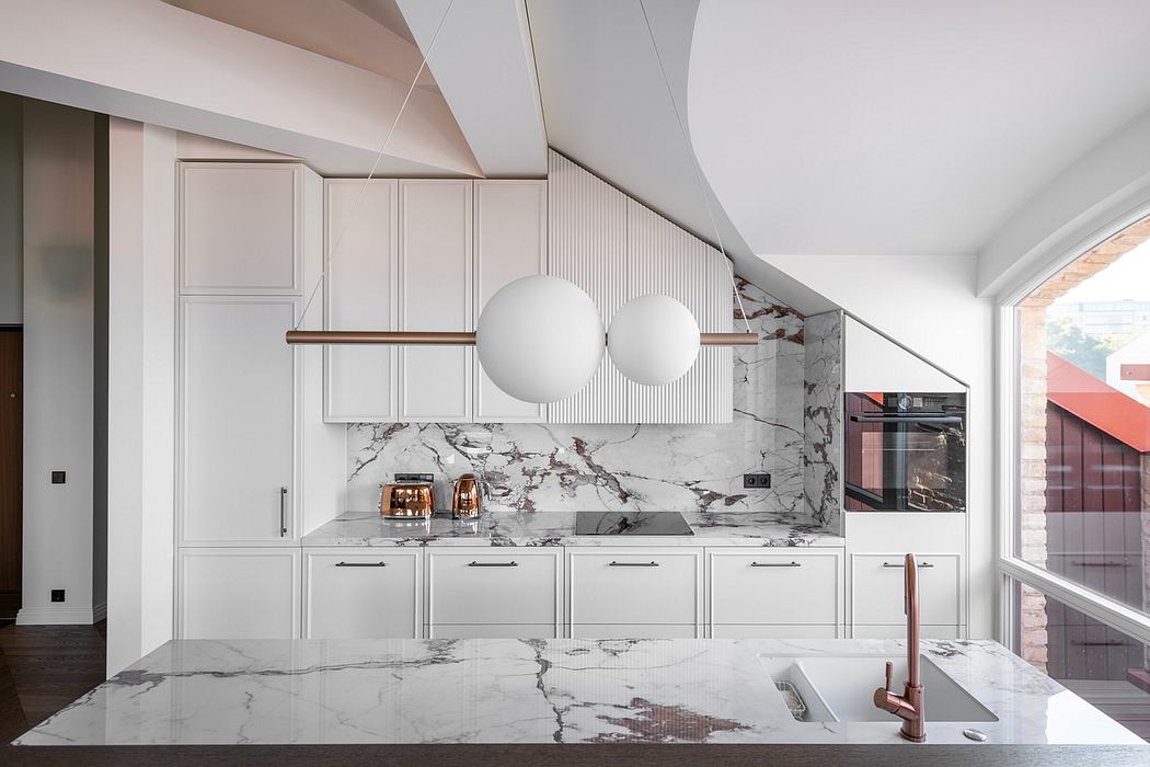 Sleek, contemporary kitchen with marble countertops, white cabinetry, and pendant lighting.