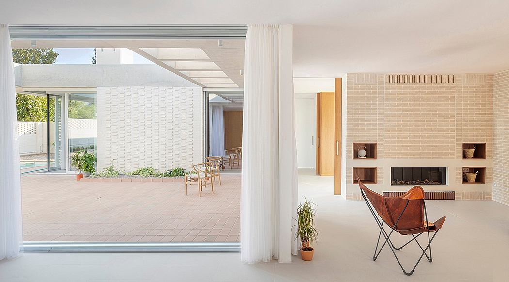 Bright, modern interior with glass walls, brick accents, and minimalist furnishings.