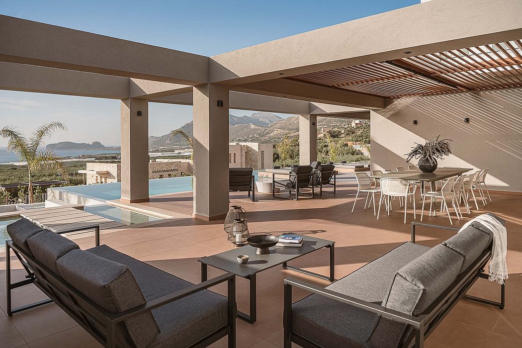 Spacious, modern outdoor living area with covered seating, dining, and pool with mountain views.