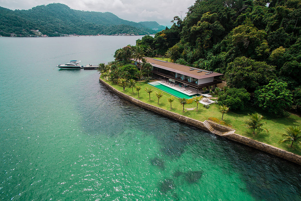 Sprawling lakeside property with a sleek modern villa, pool, and lush greenery.