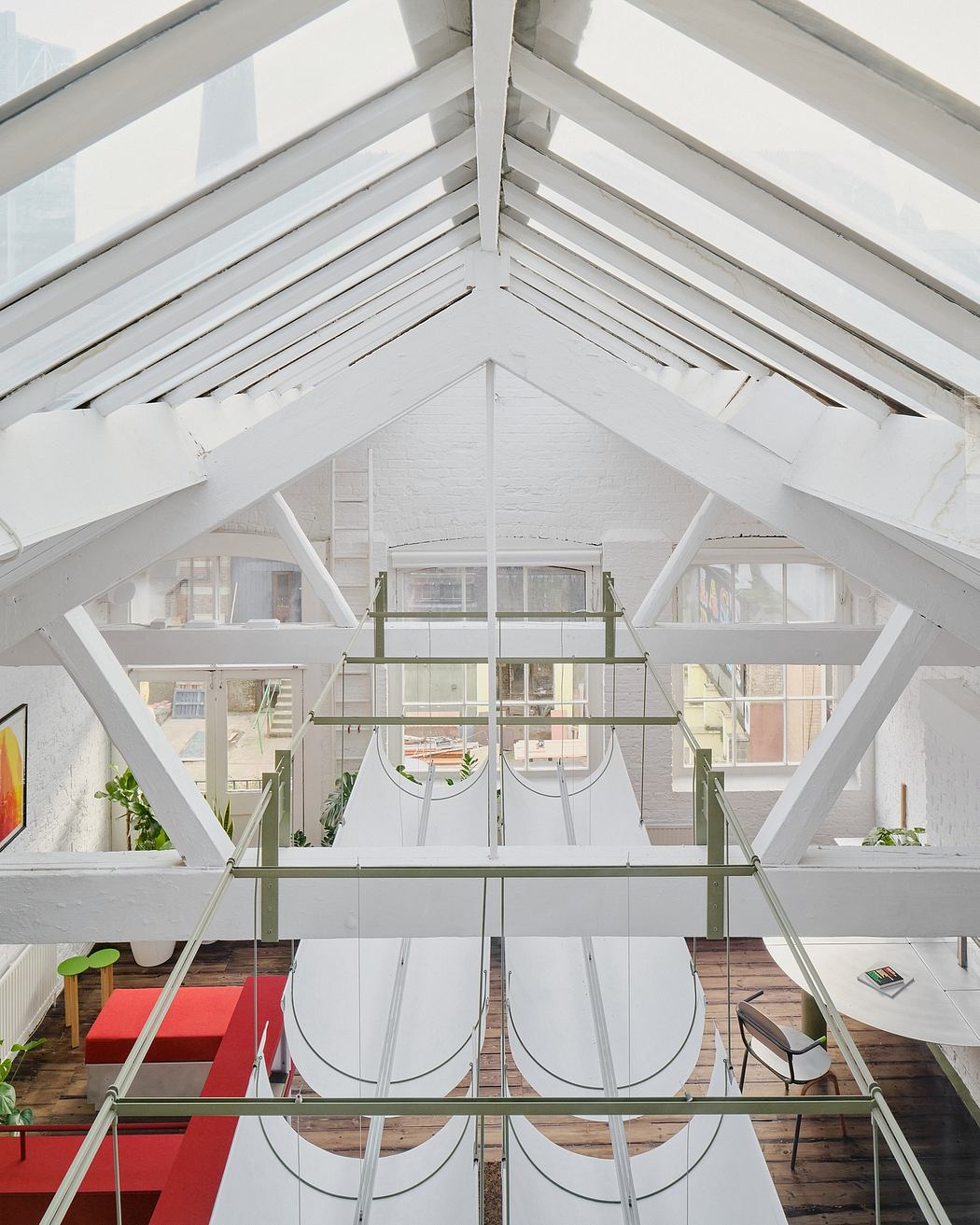 An airy, open-concept space with a modular, industrial-chic aesthetic and ample natural light.