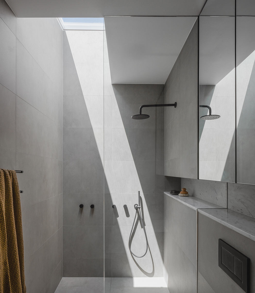 Minimalist bathroom with sleek fixtures, large mirrors, and natural light flooding the space.