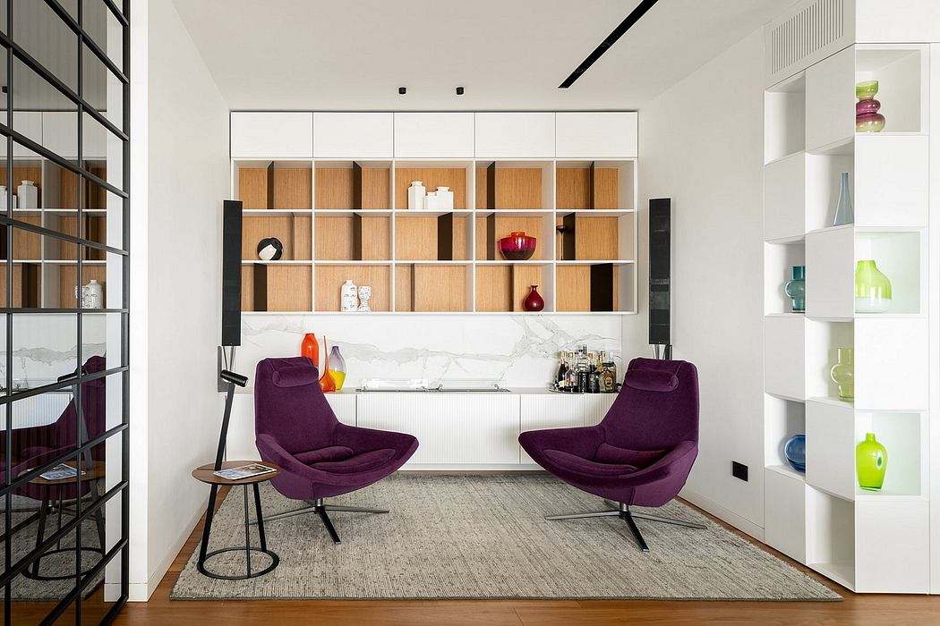 Modern, minimalist interior with built-in wooden shelving, marble countertop, and plush purple chairs.