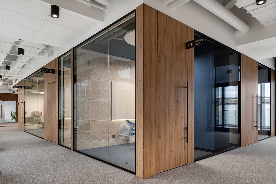 Sleek modern meeting room with floor-to-ceiling glass walls, wood accents, and minimalist decor.